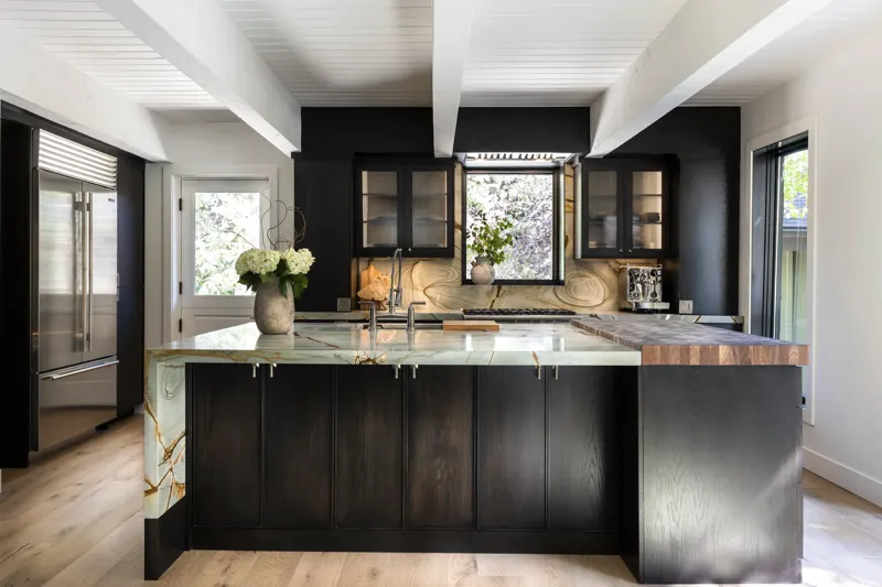 Dark-stained custom kitchen with a stone backsplash and integrated lighting — Vitruvius A-Frame project